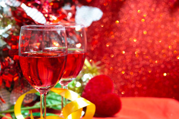 Champagne on red bokeh background. a wedding or valentine's Day concept with space for text.