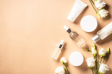 Natural cosmetic products with green leaves and flowers.