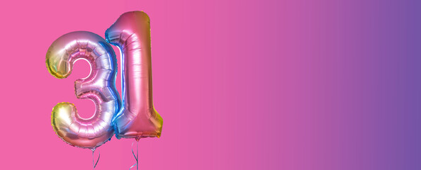 Inflatable balloons with helium in the form of the number 31 on a bright pink background with copy...