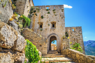 Fototapeta na wymiar Summer landscape - view of the stairs in the Klis Fortress near Split on the Adriatic coast of Croatia