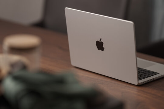 Saint-Petersburg, Russia - Circa December, 2022: open apple macbook pro 14 inch on walnut table