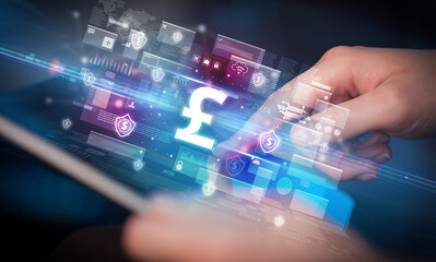 Close-up of a hand using tablet, currency concept