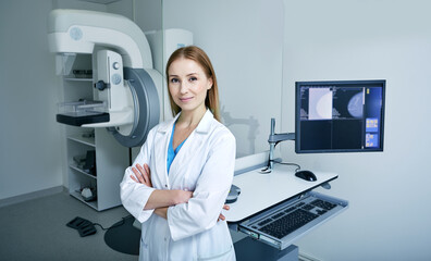 Experienced female radiologist standing near mammography workstation at radiology room of hospital. Mammography, mammogram - obrazy, fototapety, plakaty