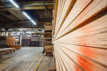Large sheets of plywood lie in the warehouse of the production, hardware store. Easy focus. Copy space.