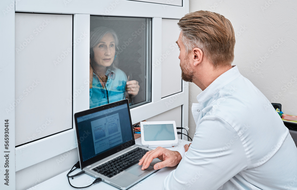 Wall mural audiometric testing. mature woman getting hearing test and audiometry at audiology center with ent d