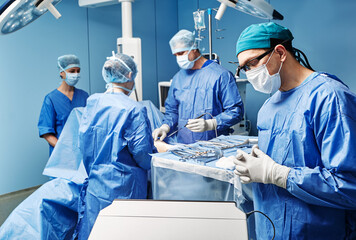 Surgical medical team performing surgical operation in modern operating room