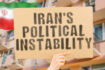 The phrase " Iran's Political Instability " is on a banner in men's hands with blurred background. Danger. Indecision. Insecurity. Catastrophe. Improvement. Disaster. Adaptation. Cataclysm. Change