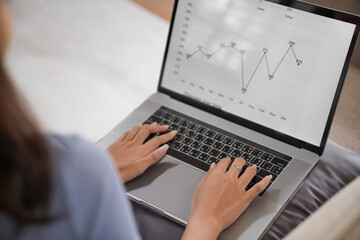 Business woman working from home. work online on laptop. Asian businesswoman working on sofa online business with social distancing laptop online meeting