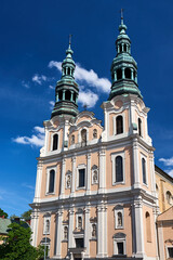 Fototapeta premium the historic, Baroque Catholic Church facade with bell towers in Poznan