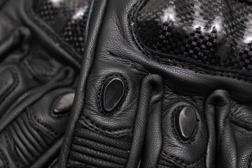 black leather motorcycle gloves. background or texture