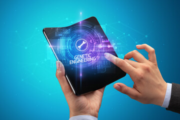 Businessman holding a foldable smartphone, technology concept