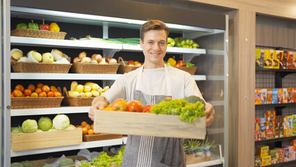 Portrait of a caucasian man working in a supermarket or retail shop and food on grocery products. Food shopping. People lifestyle. Business service. A staff worker
