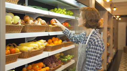 Portrait of a caucasian woman working in a supermarket or retail shop and food on grocery products. Food shopping. People lifestyle. Business service. A staff worker