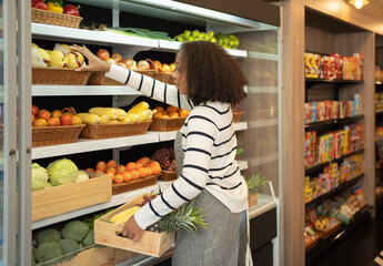 Portrait of a black african american woman working in a supermarket or retail shop and food on grocery products. Food shopping. People lifestyle. Business service. A staff worker