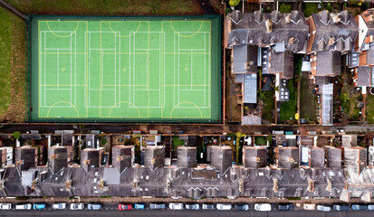 Aerial view directly above a local sports centre with pitches in a suburban neighbourhood