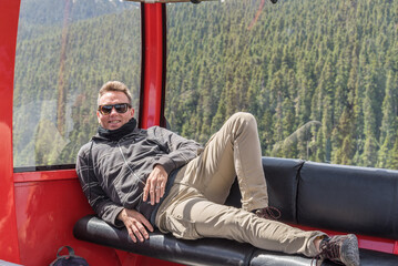Caucasian tourist in the peak to peak gondola on Blackcomb mountain, Whistler, Canada