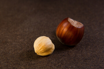 hazelnuts peeled and inshell on a dark background