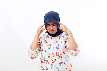 Stressed Asian muslim woman suffering head ache. Isolated on white background