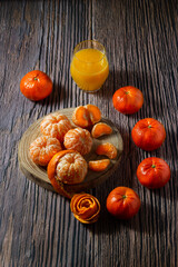 Sweet and juicy tangerines and a glass of their juice. Healthy food concept.