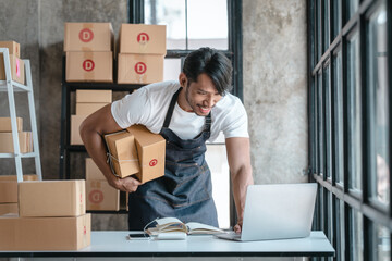 Handsome business sme owners in apron with delivery box package stock warehouse preparing after...