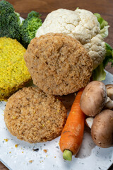 Uncooked fresh vegan and vegetarian burgers made from fresh vegetables and dried legumes and beans
