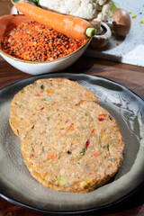 Uncooked fresh vegan and vegetarian burgers made from fresh vegetables and dried legumes and beans