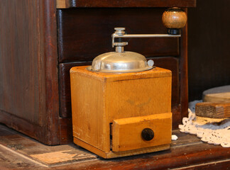 old wooden coffee grinder to pulverize the beans and prepare the drink