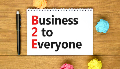 B2E business to everyone symbol. Concept words B2E business to everyone on white white note on a beautiful wooden background. Business and B2E business to everyone concept. Copy space.