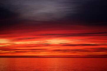 Naklejka na ściany i meble Photo of a bright red sunset on the Black Sea