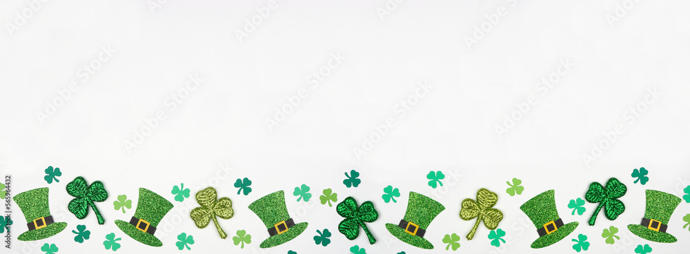 Poster st patricks day shamrock and green leprechaun hat bottom border. top view over a white banner backgr