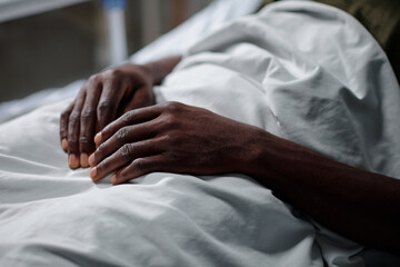 Hands of sick military man sleeping after surgery
