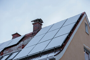 Snow-covered photovoltaic modules on a house roof do not supply electricity