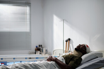 Sick military man resting in hospital ward after head surgery