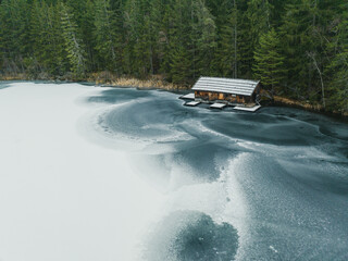 Hut at Frozen Lake Piburger See in the austrian Alps in Tyrol, Austria