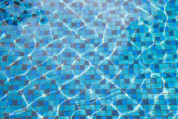 Clear swimming pool with blue ceramic tiles for background.