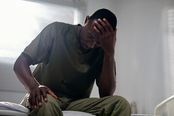 Stressed military man suffering from severe headaches after taking part in military operations