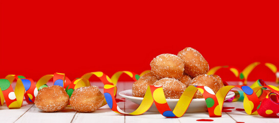 Banner with small German traditional 'Berliner Pfannkuchen', a donut without hole filled with jam....