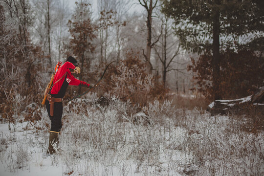 Wisconsin hunter shooting bow and arrow in winter