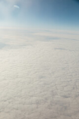 Fototapeta na wymiar bird's-eye view above the clouds flight from above
