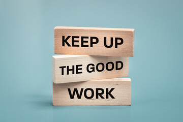 Keep up the good work, text is written on wooden blocks, Business concept, Motivating slogan, work commitment - 565980272