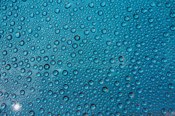 background image horizontally many drops on glass in blue