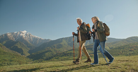 Family hiking in mountains travel adventure vacations group hikers couple trekking outdoor healthy lifestyle eco tourism 