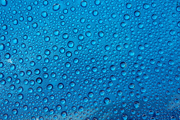 background image horizontally many drops on glass in blue