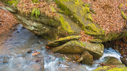 Close-up of cold winter stream flowing through rocks.