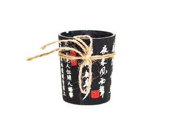Chinese black cup with hieroglyphs on a white background. Chinese wineglass isolated on white...
