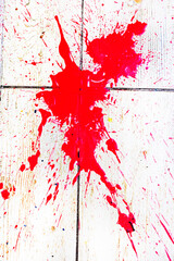 large abstract scarlet spot on a textured surface. Under the gun of a terrorist attack