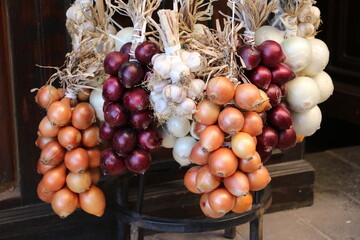 White, brown and red onion braids in Italy