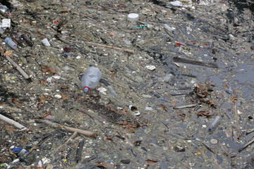 A giant floating rubbish heap floating in the river, plastic pollution, waste-clogged rivers. Huge environmental and health hazard. Problem of plastic that ends up in freshwater ecosystems.