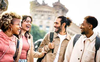 Fototapeta Multi cultural happy best friends talking and having fun at Barcelona city center - Friendship life style concept on young genz people meeting out side at college campus yard - Bright backlight filter obraz