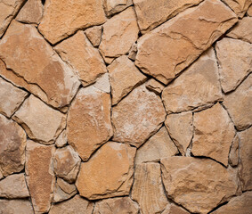 Fragment of the ancient stone wall executed from stones of various form and the size.